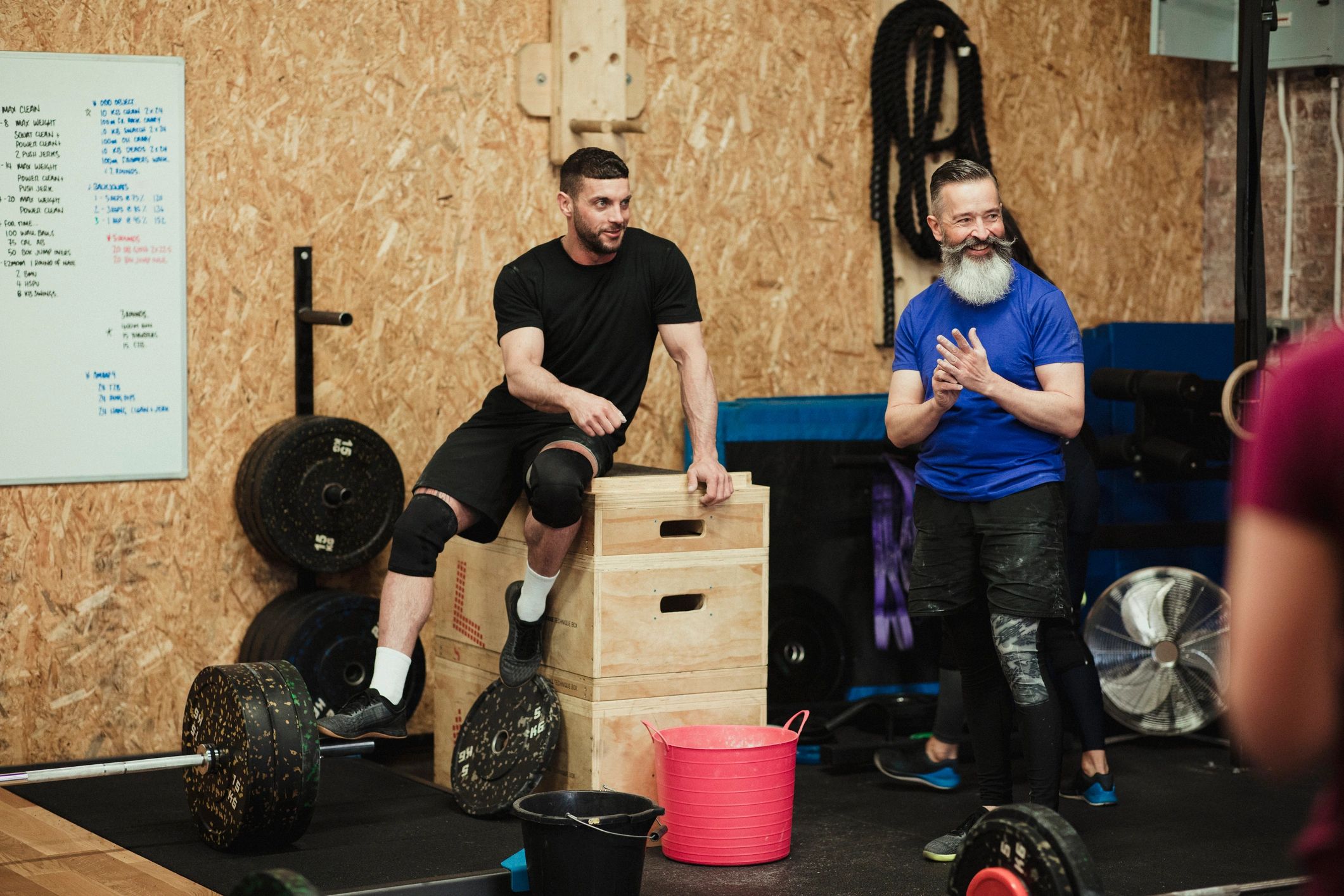 Gym member laughing during a workout conversation