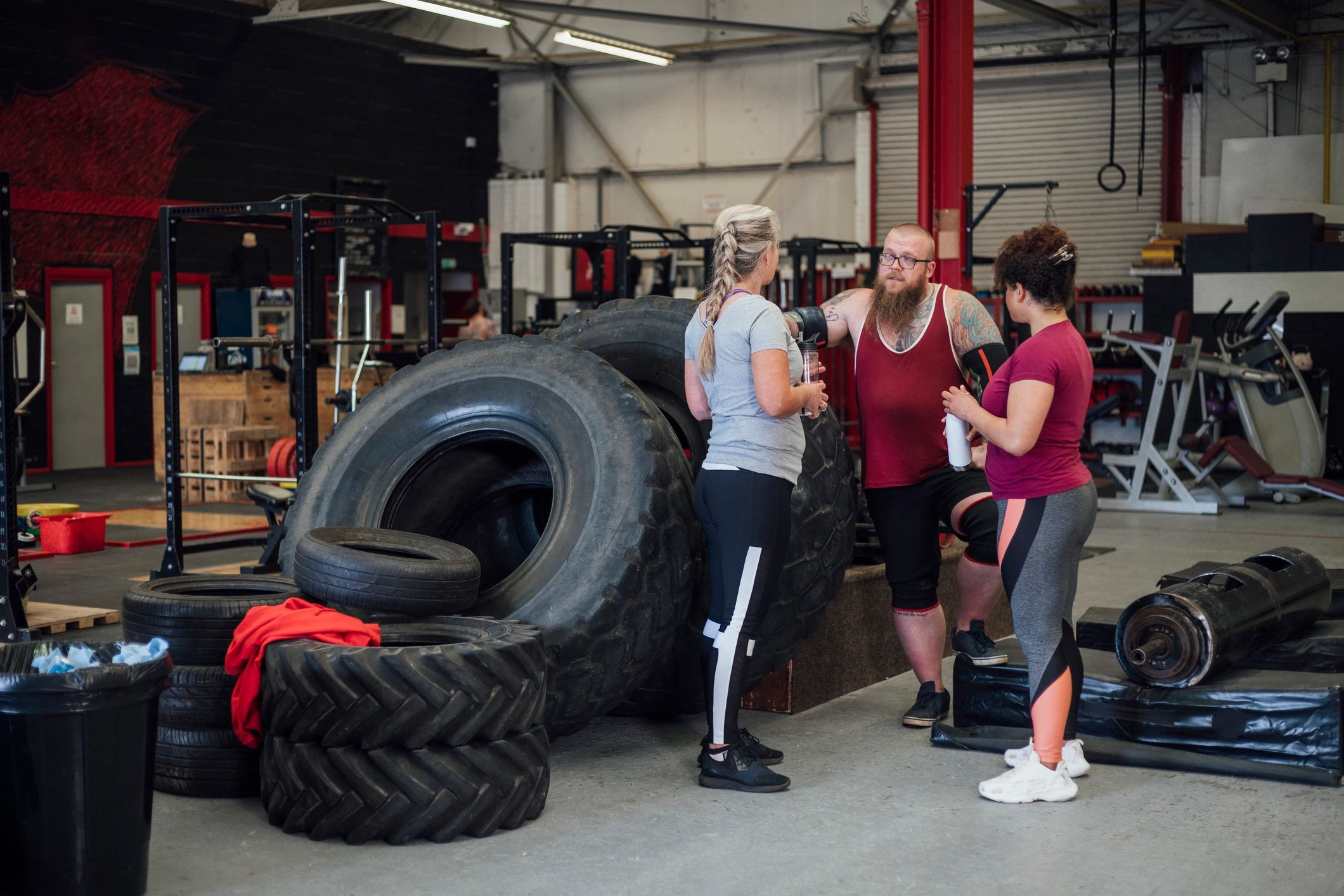 Gym members talking with a coach before training