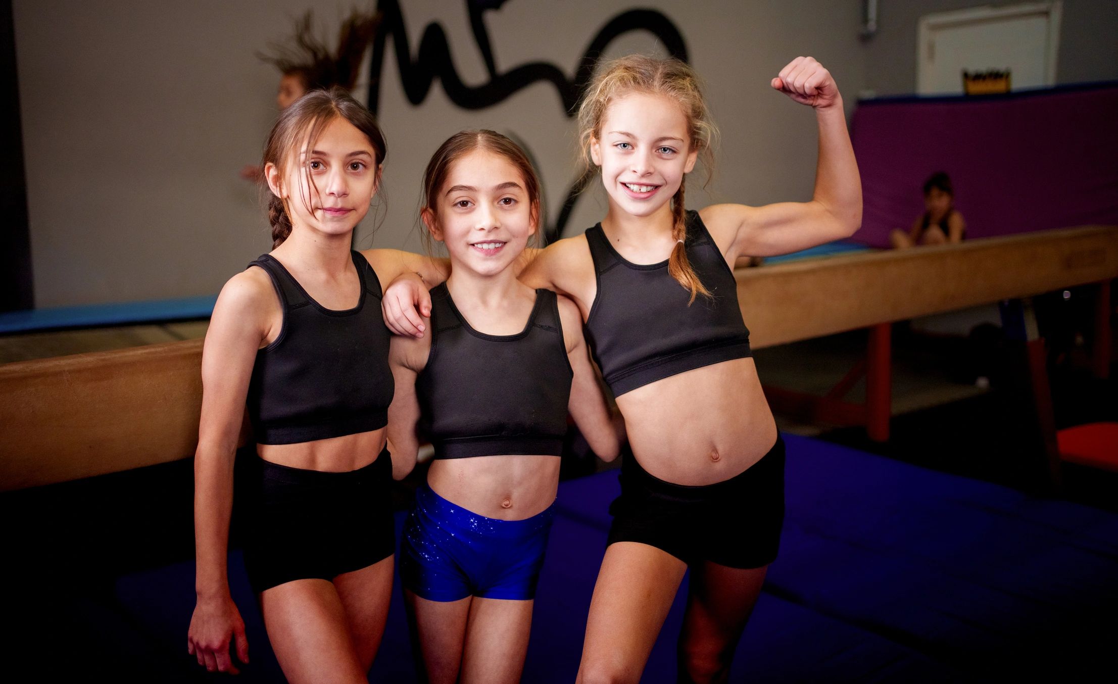 Young athletes posing confidently in a gym