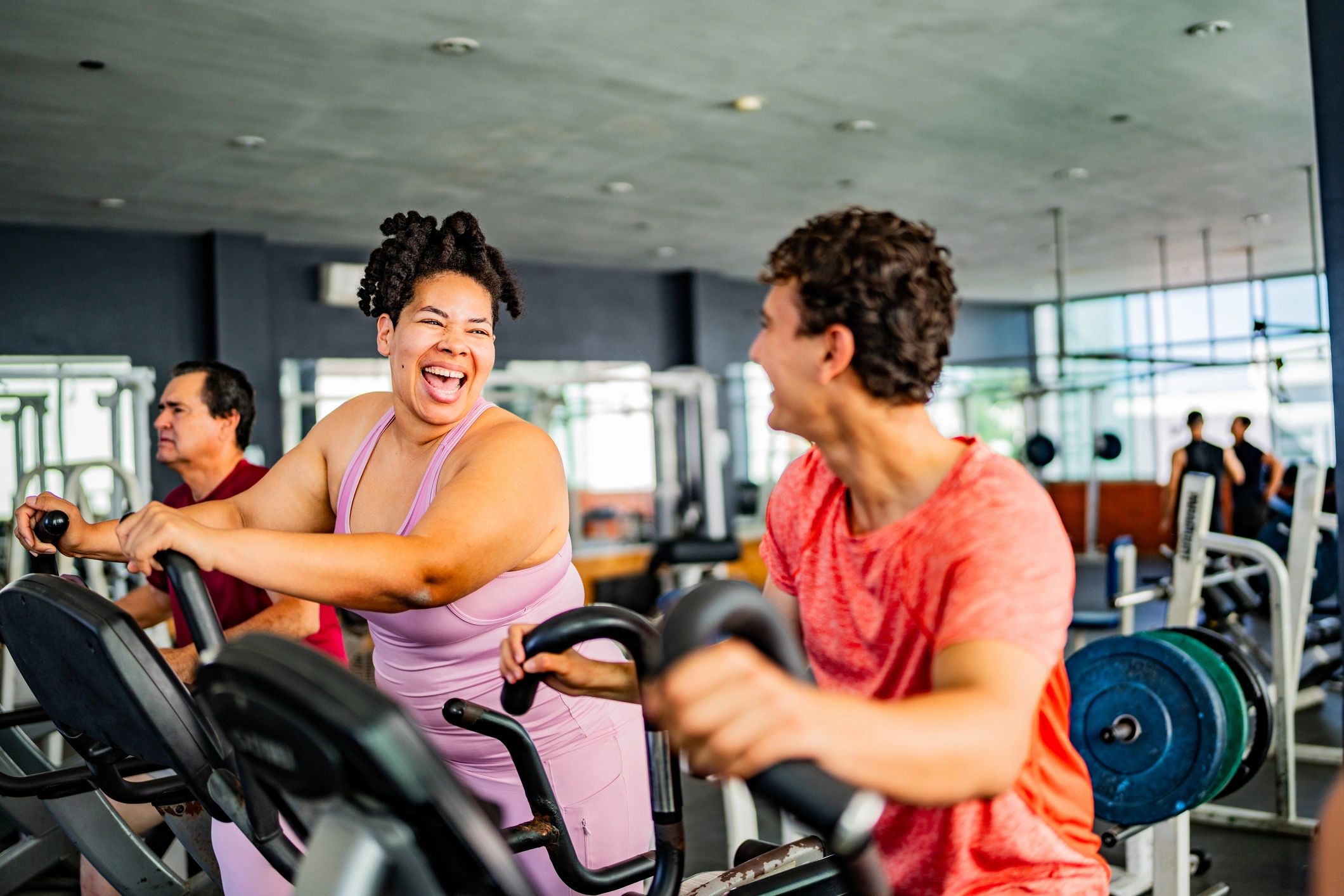 Members talking during gym cardio session
