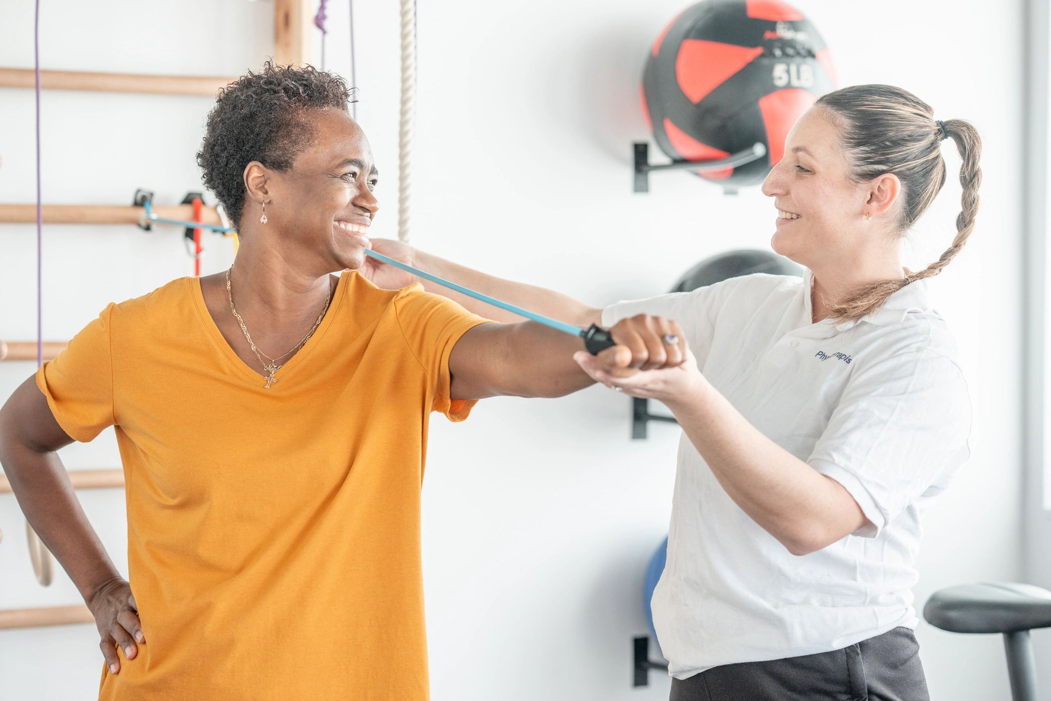 Client working with a trainer in a gym