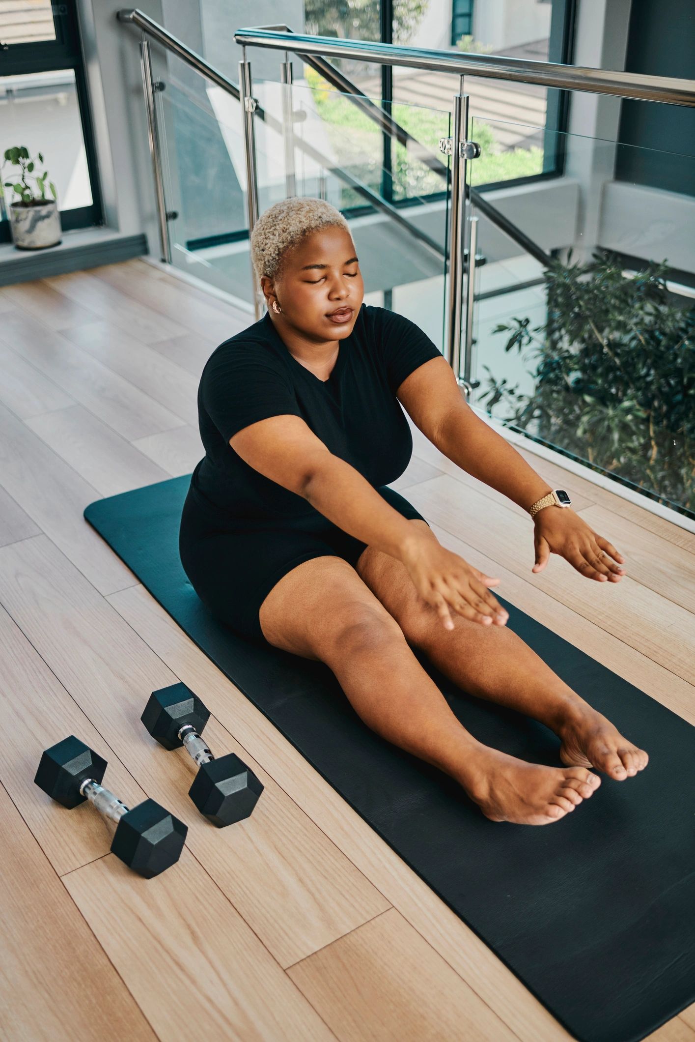 Woman stretching on a yoga mat after exercise