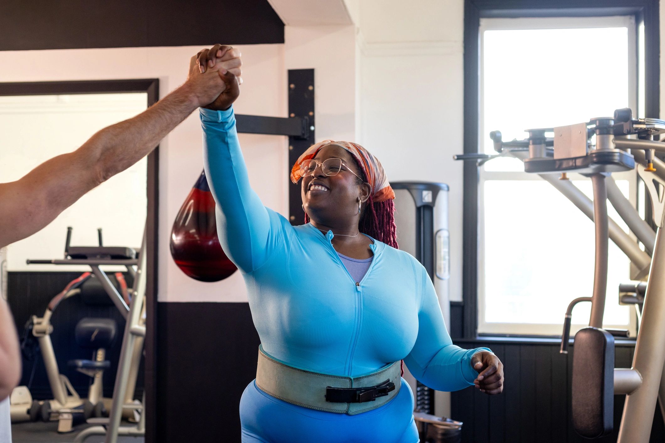 Trainer and client encouraging each other during a workout