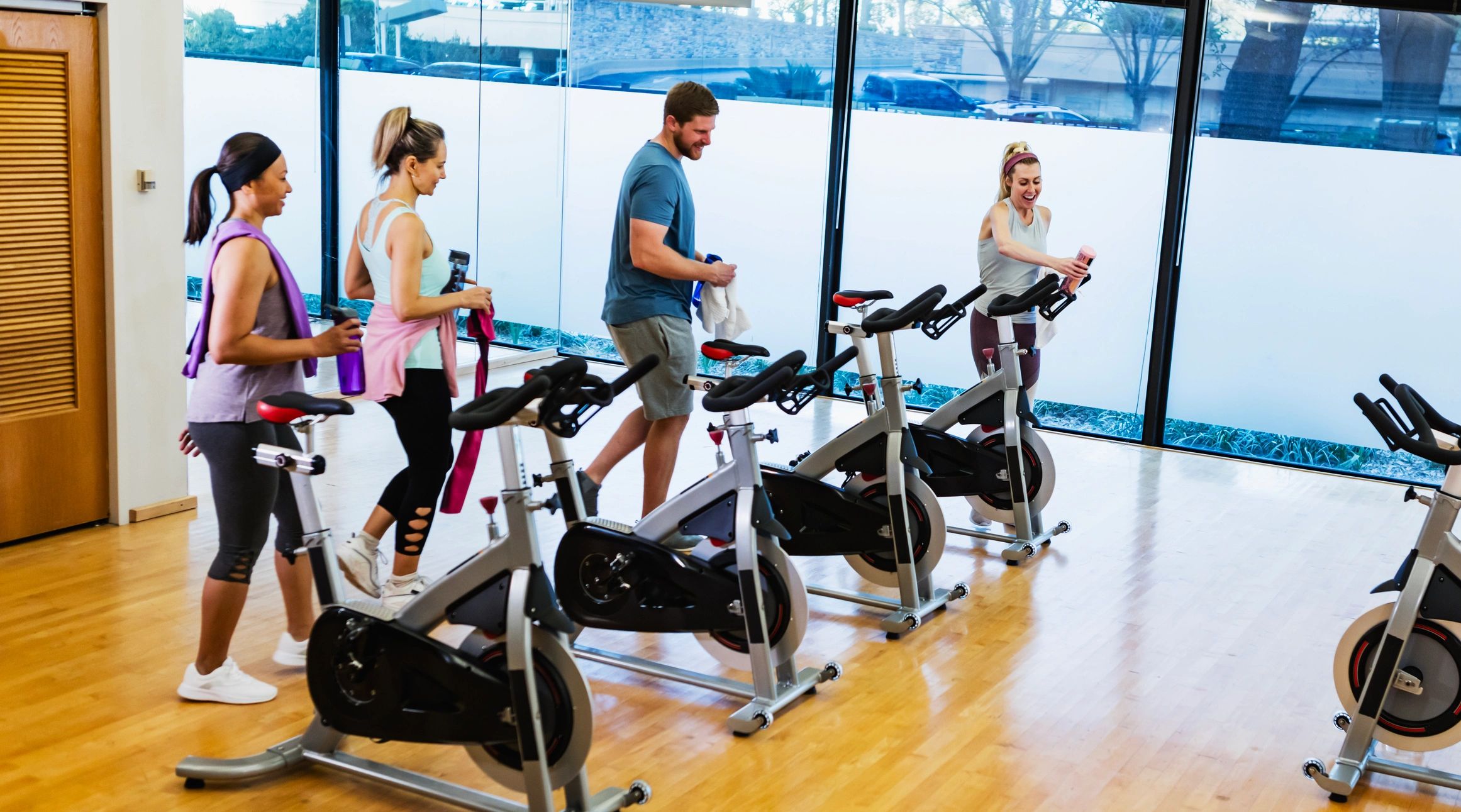 Adults getting ready to take stationary cycling class